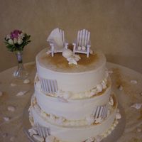 Beach Theme Wedding Cake Beach theme wedding cake, adirondack chairs, brides has a fondant beach towel with wedding bells imprinted, grooms chair has a fondant golf...