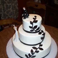 Black And White Wedding Buttercream with MMF leaves and satin ribbon.