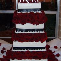 Black/white And Roses All buttercream with satin ribbon. Thank goodness I took another cake friend with me to put all the fresh roses in between the pillars...it...