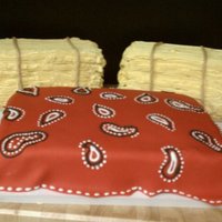 Hay Bale And Bandana Red fondant with royal icing bandana pattern. Hay bales are buttercream with fondant "rope".
