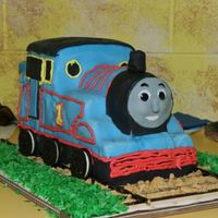 Thomas The Tank Engine Made this cake for my son's 2nd birthday. Layered chocolate cake. 12" long, 6" wide, 8" tall. Fondant covered, my first...