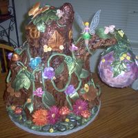 Tinkerbell's House Cake-Front White cake with rasphberry buttercream filling. Fondant and gumpaste.