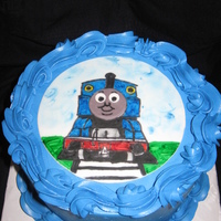 Nehemiah's Thomas The Train Vanilla cake with cookies and cream filling, blue Vanilla Buttercream, and a Thomas fondant scene.