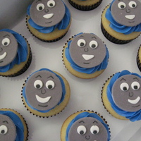 Thomas Cupcakes Vanilla cupcakes filled with cookies and cream buttercream, blue Vanilla buttercream, and a fondant Thomas face..