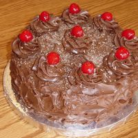 Black Forest Cake.... I made this devil's food cake with cherry pie filling and milk choc. frosting with cherries and choc. shavings on top for my Grandma&#...