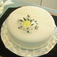 One Layer Wedding Cake For Small Family Wedding Chocolate cake with bavarian cream filling. Buttercream icing covered in fondant with royal icing flowers and fondant daisies.