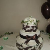 Round Wedding Cake Top and Bottom layer is chocolate with raspberry filling and the middle layer is white cake with strawberry filling. Fondant on each layer...