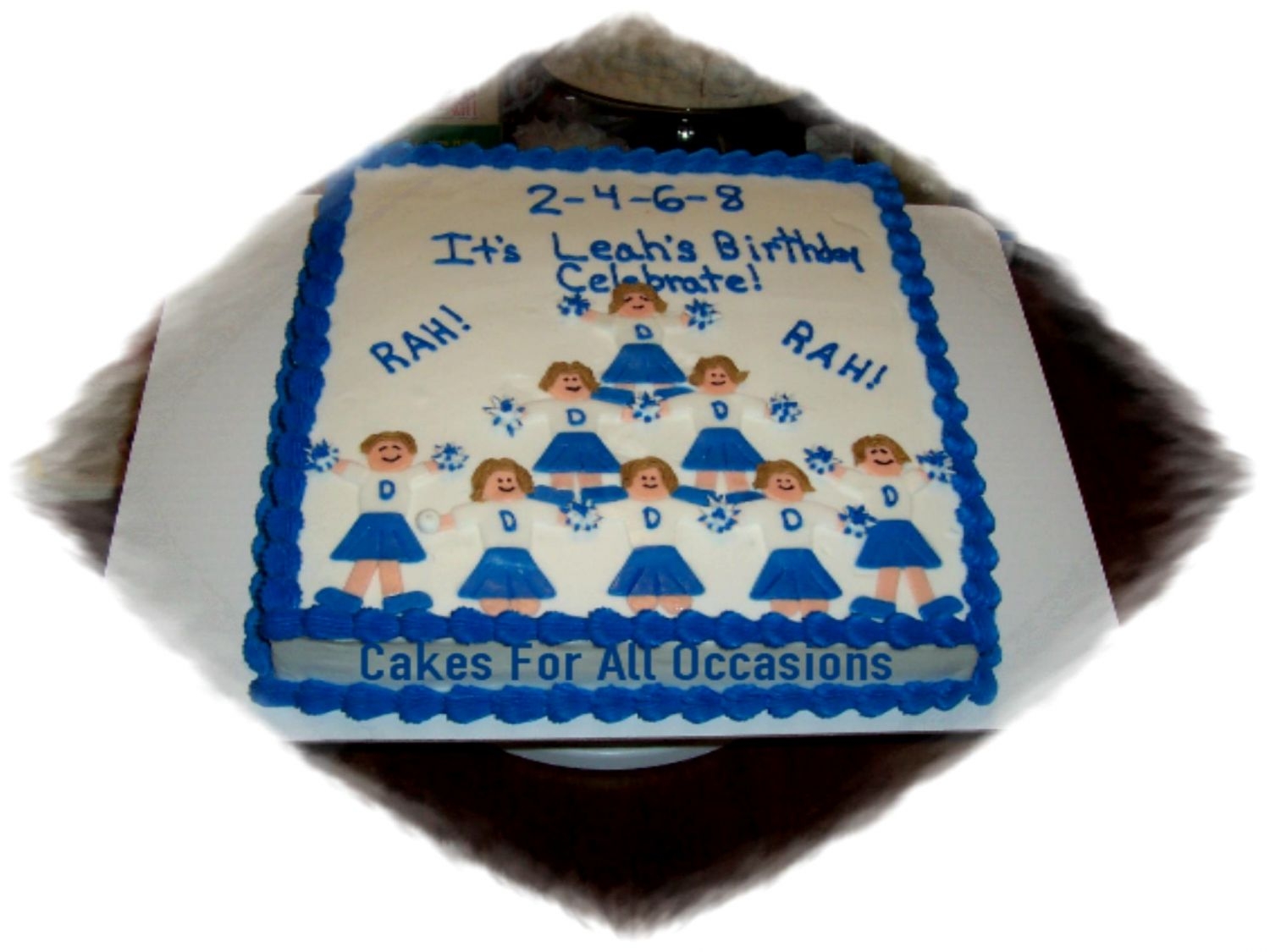 Rah! Rah! Square cake with fondant cheerleaders, buttercream icing. OOPS. I forgot a pom pom. Was in a hurry.