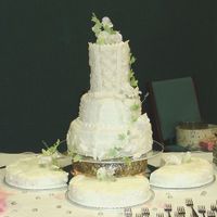 Three-Tier Spring This is a three tier wedding cake I did last month. I designed it after the bride's dress with a corsetted top, matching lace...