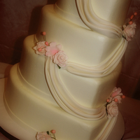 Heart Shaped Wedding Buttercream icing, fondant swag (my first time doing this, luckily it turned out!) and sugar flowers. The client had a topper for this cake...