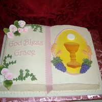 First Communion Italian buttercream with fondant accents and pressed sugar chalice and host. Flowers are gumpaste