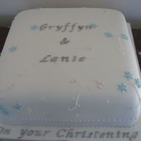 Christening Cake For Siblings Done at 3 in the morning--what a disaster!!! Had loads of trouble moving my cake to the fondant covered board. Vanilla cake with Chocolate...