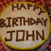 Carpenter Birthday Cake Chocolate and vanilla double layer cake with chocolate chip filling. Made to look like wood and nails.