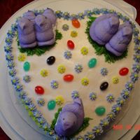 Spring Cake Funfetti cake with vanilla buttercream frosting. Decorated with peeps, jelly beans and drop flowers.