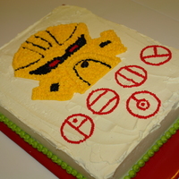 Lego Bionicle Dekar Mask Cake My son wanted one of his beloved Lego Bionicle's mask made into a cake. He handed me the tiny yellow mask of Mahri Nui Matoran Dekar....