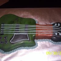 Picture_018.jpg Groom's guitar cake. Chocolate fudge cake covered in all fondant.
