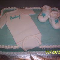 Baby Onsie And Booties I made this cake for my sister in law, she loved it.Buttercream icing, fondant onsie and booties.