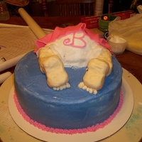Baby Butt this is a 10" round and a meduim bowl cake. legs and feet are rice krispy treas covered in fondant. the dress is also fondant.