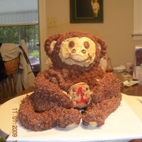 Monkey Cake monkey cake was made with 3-d bear cake pan he is covered in buttercream. His arms legs and tail are fondant. Holding a cookie. the...