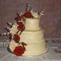 My First Wedding Cake And I Just Finished Course 1 All BC with Carrot cake on top tier, middle and bottom white cake. Roses are silk.