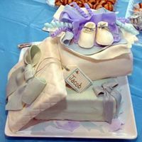 Jacob's Cake MMF on "box" cakes; gum paste bow & gift tag; RBC mixed with cornstarch made the booties; quilted box lid is Rice Krispy...