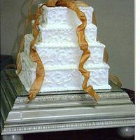 Parent's 50Th Anniversary Square french vanilla cakes with BC frosting. Ribbon bow on top. Stand was built by my father.