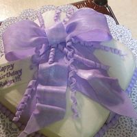 Another Present Cake This was ordered for a co-worker of mine. Cake is buttercream (they didn't want fondant) so it was a challenge. The bow, curly cues...