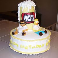 Homer Simpson And Birthday Boy I made this cake for my husbands best friend. This is was taken before the mug fell off. (bumpy car ride!) I was able to repair it, but the...