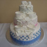 Php8Rjgptpm.jpg wedding cake covered in fondant with fondant bows, accents and silver dragees.