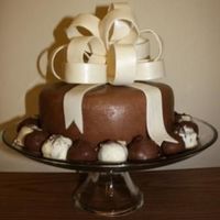 Happy Birthday Chocolate cake with chocolate buttercream and covered in chocolate fondant. The base is surrounded with 'mudslide' cake truffles...