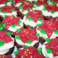 Christmas Brownies Brownies baked in mini muffin pans topped with buttercream poinsettias.