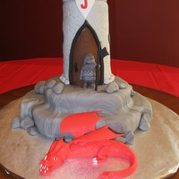 Knight Cake With Dragon I made this for my son's 4th birthday. The "rock" base is yellow cake covered in marbled fondant. The castle is rice krispie...