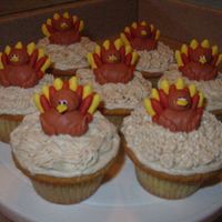 Turkey Cupcakes Turkeys are piped out of royal icing and sit on cinnamon cream cheese frosting.