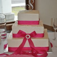 White Wedding Cake With Pink Detail This is a WASC cake, with raspberry and white chocolate buttercream filling. It is covered and piped in white chocolate buttercream