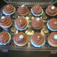 Brown And Blue Cupcakes. I made these cupcakes to go along with the last cake that I posted. White cake w/ chocolate BC, decorated with blue fondant and dragees.