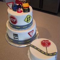 Traffic Signs Cake. Made this for a little boy's first birthday. Iced in BC. Fondant signs and road.