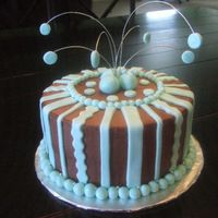 Brown And Blue Birthday Cake. 8" white cake with chocolate mousse filling, iced in choc. BC and decorated with fondant. The brown and blue was requested by the...