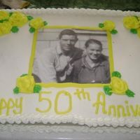 50Th Wedding Anniversary 1/2 sheet white cake with bc icing. The pic was printed from my pc and had contact paper attached to each side. It was an easy cake to do...