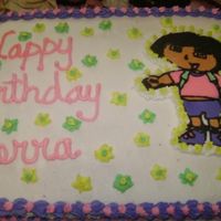 Dora The Exlplorer 1/2 sheet white cake with a almond flavored bc icing and a fbct