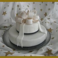 Anniversary Cake 9 and 6 Inch chocolate cake covered with fondant and gum paste bow. The request was a simple cake for a wedding anniversary.