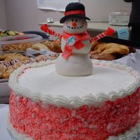 Dsc00994.jpg Cake was for a christmas party. The snowman is in fondant. The sides of the cake were crushed candy cane. The cake was dark chocolate with...