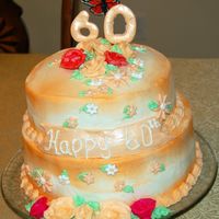 60Th Birthday Cake made for my Mother in Laws 60th birthday. 10" and 8" stacked.Fondant w/luster dust to make the sign and the "60"