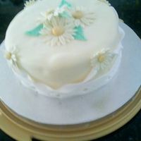 Ellens_B-Day_Cake.jpg Yellow fondant covered cake with fondant and gumpaste accents.Cake is white chocolate-raspberry with raspberry buttercream filling.