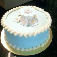 Paul_B-Day_Cake.jpg Lemon cake with lemon buttercream filling. Blue buttercream with gumpaste accents.
