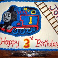 Thomas The Train Birthday Cake Chocolate/french vanilla sheetcake with bc frosting. Thomas character cake on top.