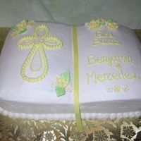 Twin Baptism Yellow cake with strawberry filling. Shaped like a bible with buttercream icing and sugar roses.