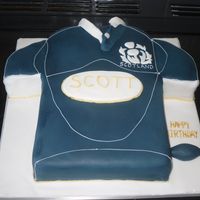 Scotland Rugby Shirt Carved from 2 8" square cakes. Getting the colour right was very hard! Thank goodness for ready coloured black and royal blue icing!...