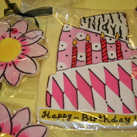 Birthday Cake Cookie And Flowers NFSC decorated with glace. The flowers were white, and I painted them with gel food color and vodka. All of the black on the cake and...