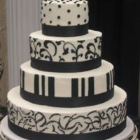 Heather's Cake Butter Pecan Cake with buttercream icing and freehand black detail work.