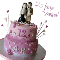 12,5 Year A Couple! With pale pink and wedding topper made out of clay, the couple, themselves, as keepsake!